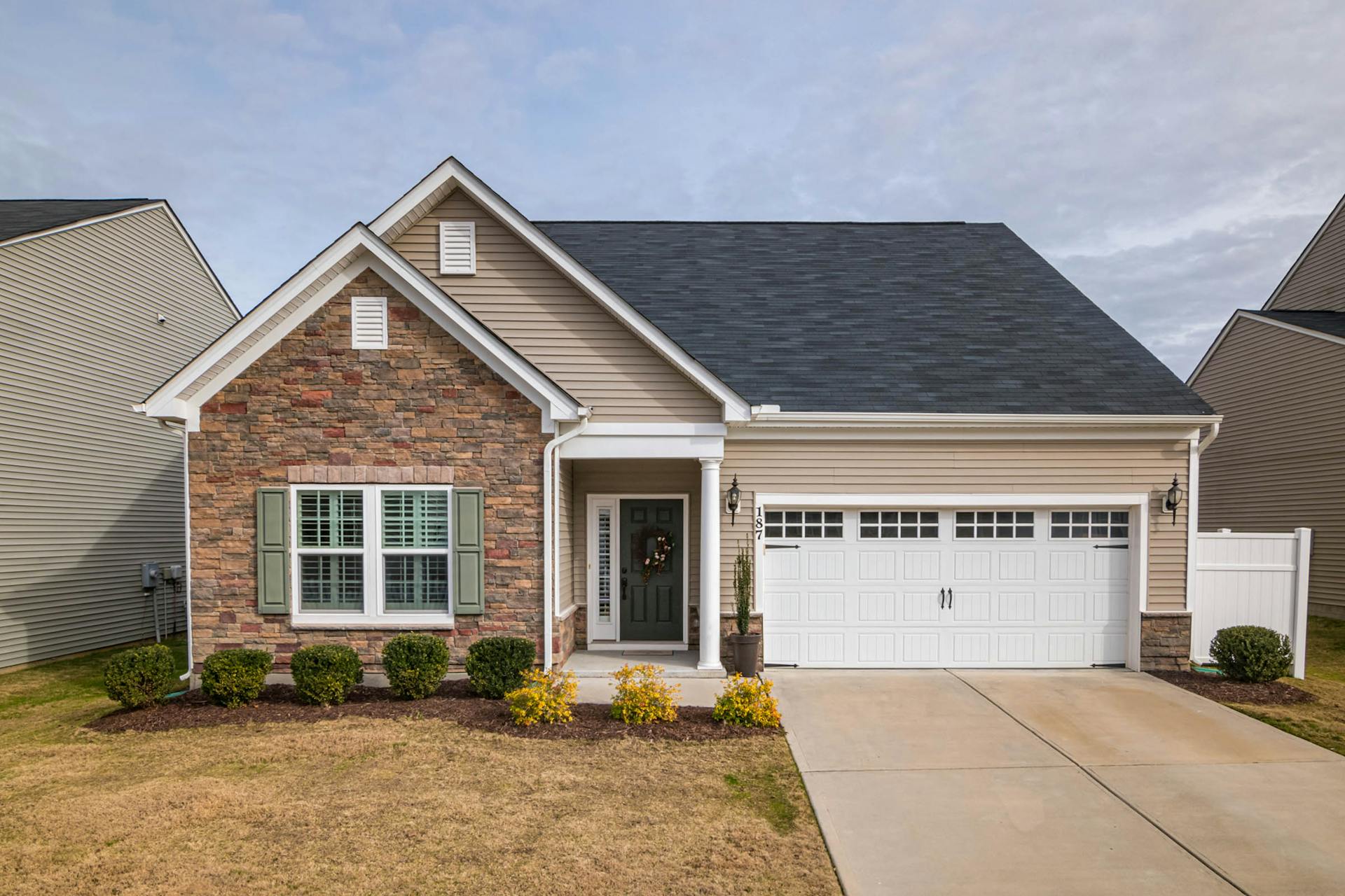 House with white carriage house garage doors